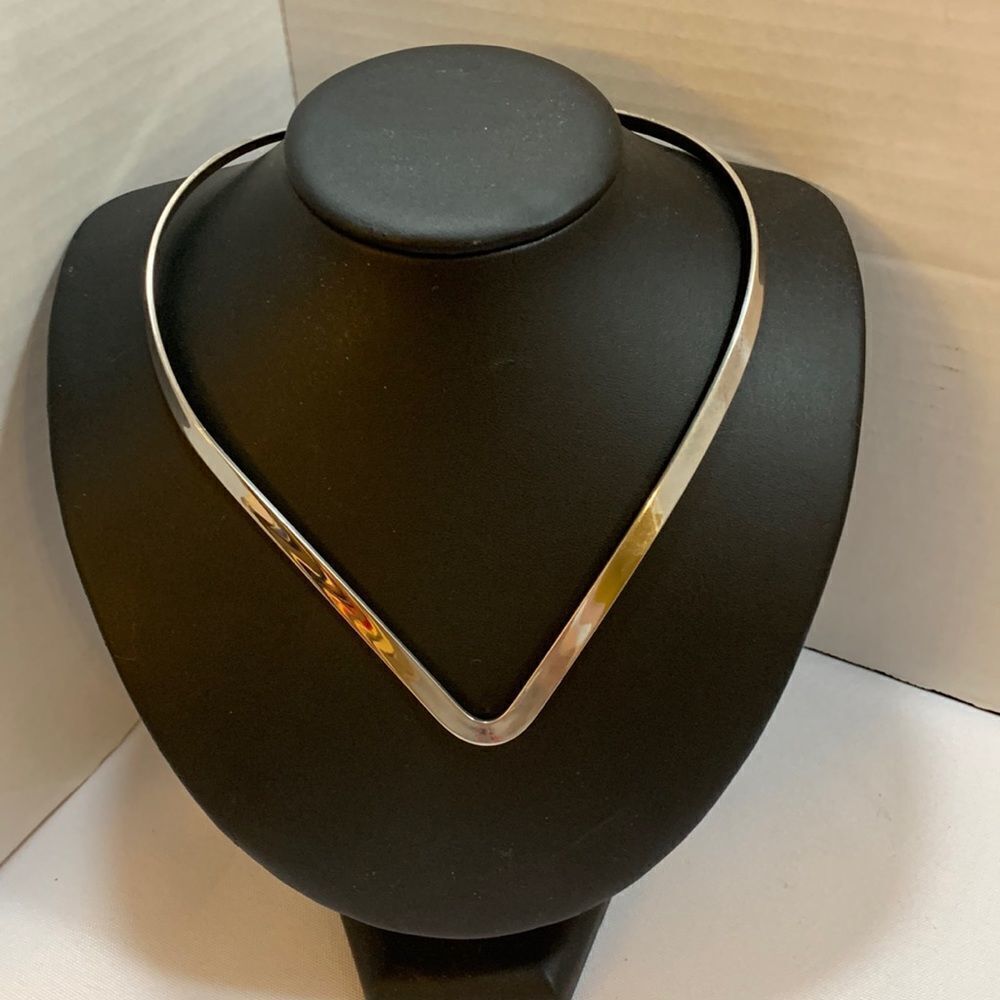 Silvertone V-shaped choker.  Great to use your clip on pendants/scarf holder on